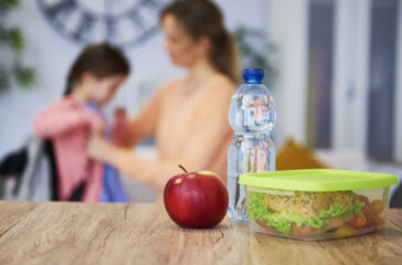 Healthy school lunch box with sandwich and fresh vegetables