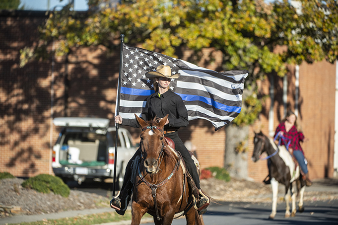 Carol Buchanan of Bisco rides Matt Dillon a Mustang rides down Sunset drive during the 20th annual Asheboro Fall Roundup Horse Parade in downtown Asheboro, on Nov. 7, 2021. (PJ WARD-BROWN/NORTH STATE JOURNAL)