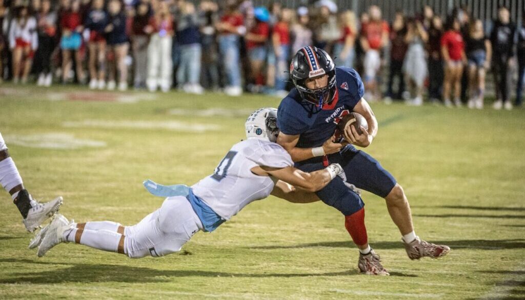 PG football Logan Fox and Trinity defender Jason Brown