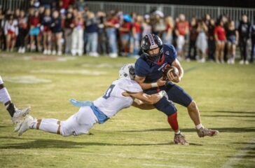 PG football Logan Fox and Trinity defender Jason Brown