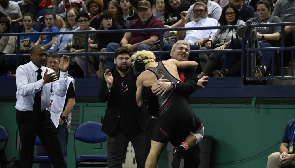 Wheatmore wrestling Ayden Sumners with coach after 2025 final